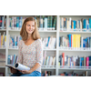 Cute female university/highschool student with books in library
