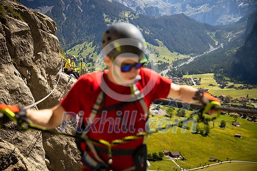 Young people on a via ferrata route in Swiss Alps