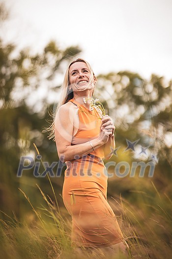 Portrait of a relaxed middle aged woman outdoors, looking happy, enjoying the life Portrait of a relaxed middle aged woman outdoors, looking happy, enjoying the life