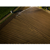 Intense agriculture fiekd being irrigatedwith huge amounts of water on a hot summer day - aerial image