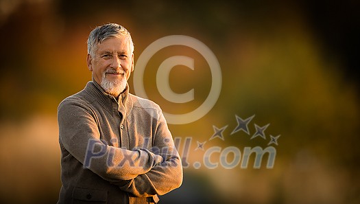Portrait of handsome senior man in the autumn outdoors. Active senioor enjoying his retirement in the nature Portrait of handsome senior man in the autumn outdoors. Active senioor enjoying his retirement in the nature