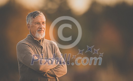 Portrait of handsome senior man in the autumn outdoors. Active senioor enjoying his retirement in the nature Portrait of handsome senior man in the autumn outdoors. Active senioor enjoying his retirement in the nature