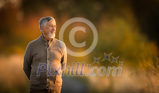 Portrait of handsome senior man in the autumn outdoors. Active senioor enjoying his retirement in the nature Portrait of handsome senior man in the autumn outdoors. Active senioor enjoying his retirement in the nature