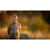 Portrait of handsome senior man in the autumn outdoors. Active senioor enjoying his retirement in the  nature