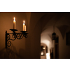 Splendid chandelier with lit candles in a beautiful room of an old mansion