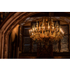 Splendid chandelier with lit candles in a beautiful room of an old mansion