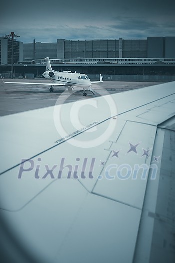 Private jet waiting for its busy owner, ready for flight, in an airport