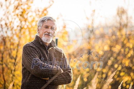 Happy senior man enjoying a lovele autumn day outdoors Happy senior man enjoying a lovele autumn day outdoors
