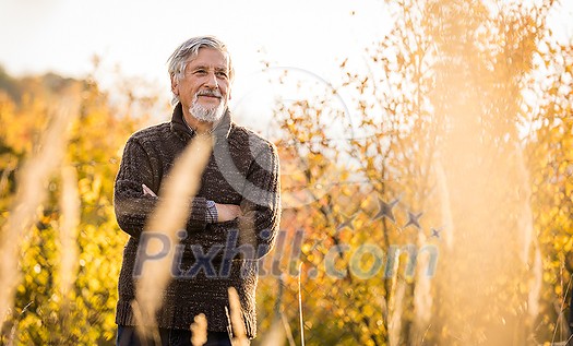 Happy senior man enjoying a lovele autumn day outdoors Happy senior man enjoying a lovele autumn day outdoors