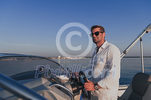 A determined senior businessman in casual clothes and sunglasses enjoys his vacation driving a luxury boat at sunset. Selective focus. High-quality photo A determined senior businessman in casual clothes and sunglasses enjoys his vacation driving a luxury boat at sunset. Selective focus. High-quality photo