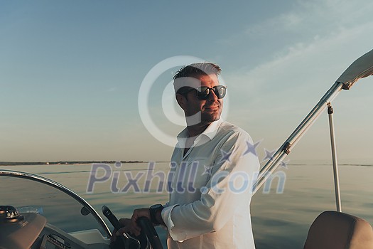 A determined senior businessman in casual clothes and sunglasses enjoys his vacation driving a luxury boat at sunset. Selective focus. High-quality photo A determined senior businessman in casual clothes and sunglasses enjoys his vacation driving a luxury boat at sunset. Selective focus. High-quality photo