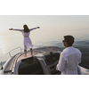 A senior couple in casual outfits with their son enjoy while riding a boat at sea at sunset. The concept of a happy family. Selective focus. High-quality photo