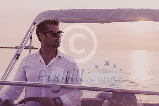 A determined senior businessman in casual clothes and sunglasses enjoys his vacation driving a luxury boat at sunset. Selective focus. High-quality photo