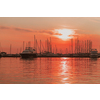 Sunrise on the seashore. In the silhouette of the ships in the harbor. Selective focus. High-quality photo