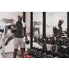 Struggling with age. Confident senior man exercising with dumbbells in the health club. Selective focus. High-quality photo