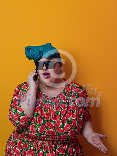 Trendy plus size woman having conversation talking by smartphone over yellow background smiling with an idea or question pointing finger with happy face, number one. High quality photo