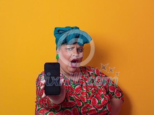 Trendy plus size woman having conversation talking by smartphone over yellow background smiling with an idea or question pointing finger with happy face, number one. High quality photo