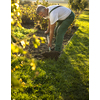 Senior gardener gardening in his permaculture garden - turning over the soil in his garden with a spade