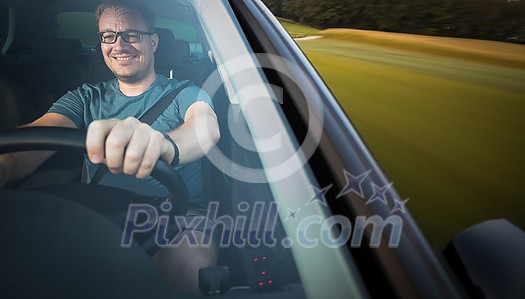Handsome young driver driving hic car fast yet safely on the road (motion blurred image) Handsome young driver driving hic car fast yet safely on the road (motion blurred image)