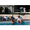 The happy family enjoys vacation in a luxury house with a pool. The senior couple spends time with their son during the vacation. Selective focus. High-quality photo