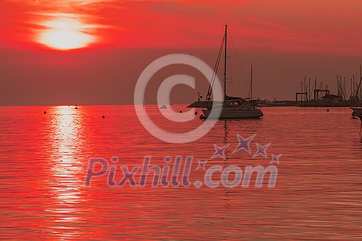 Sunrise on the seashore. In the silhouette of the ships in the harbor. Selective focus. High-quality photo Sunrise on the seashore. In the silhouette of the ships in the harbor. Selective focus. High-quality photo
