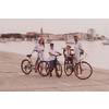 The happy family enjoys a beautiful morning by the sea riding a bike together and spending time together. The concept of a happy family. High-quality photo