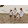 Senior couple in casual clothes with their children, boy and girl enjoy the beach spending a vacation together. Family time. Selective focus. High-quality photo