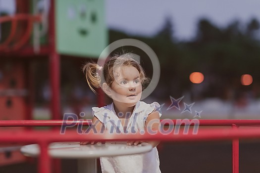 A little girl in modern summer clothes playing in the park in summer. Selective focus. High-quality photo A little girl in modern summer clothes playing in the park in summer. Selective focus. High-quality photo