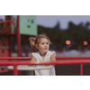 A little girl in modern summer clothes playing in the park in summer. Selective focus. High-quality photo