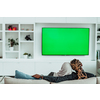 African Couple Sitting On Sofa Watching TV Together Chroma Green Screen Woman Wearing Islamic Hijab Clothes. High quality photo