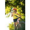 Pretty, young woman biking on a mountain bike enjoying healthy active lifestyle outdoors in summer (shallow DOF)