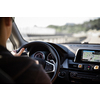 Driver at a steering wheel of a modern car (shallow DOF; color toned image)