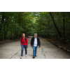 Active handsome senior walking, hiking outdoors on a forest path, enjoying his retirement with his daughter