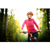 Pretty, young woman biking on a mountain bike enjoying healthy active lifestyle outdoors in summer (shallow DOF)