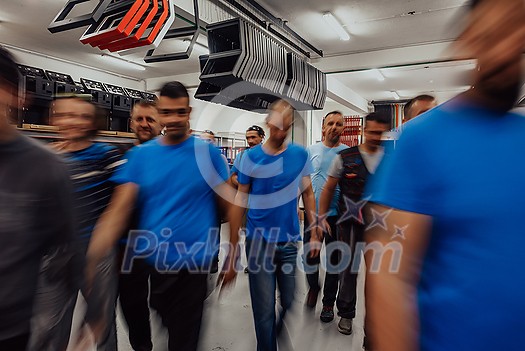 Blurred movement of workers in the modern heavy industry while doing the jobs they are in charge of. Blurred photo. Selective focus. High-quality photo