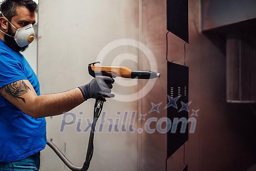 The painter paints the iron element. Industrial painting parts. Metal designs. High-quality photo The painter paints the iron element. Industrial painting parts. Metal designs. High-quality photo