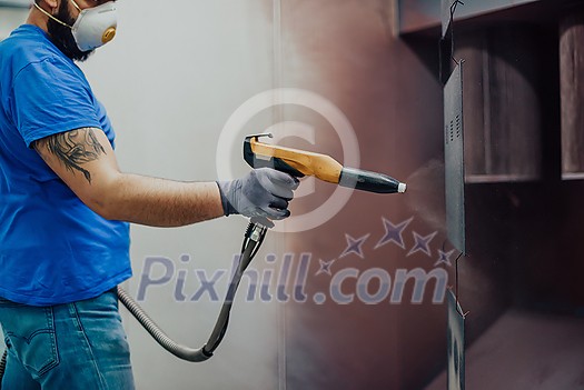 The painter paints the iron element. Industrial painting parts. Metal designs. High-quality photo