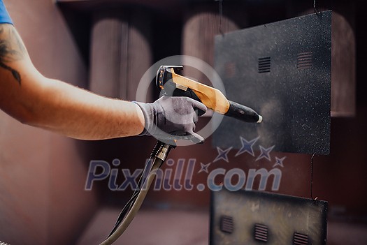 The painter paints the iron element. Industrial painting parts. Metal designs. High-quality photo The painter paints the iron element. Industrial painting parts. Metal designs. High-quality photo