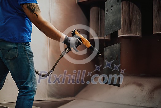 The painter paints the iron element. Industrial painting parts. Metal designs. High-quality photo The painter paints the iron element. Industrial painting parts. Metal designs. High-quality photo