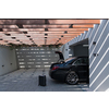 A photo of a suitcase standing next to a car in a luxury garage. High-quality photo