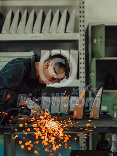 Heavy Industry Engineering Factory Interior with Industrial Worker Using Angle Grinder and Cutting a Metal Tube. Contractor in Safety Uniform and Hard Hat Manufacturing Metal Structures. High-quality photo Heavy Industry Engineering Factory Interior with Industrial Worker Using Angle Grinder and Cutting a Metal Tube. Contractor in Safety Uniform and Hard Hat Manufacturing Metal Structures. High-quality photo