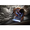 Pretty, middle-aged woman using her laptop computer before sleep in bed in the evening