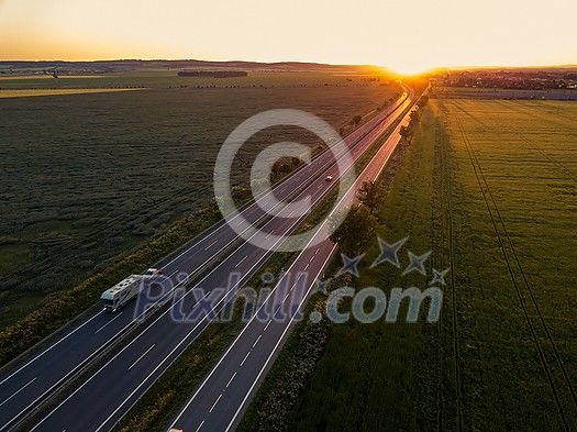 Cars on the road at sunset. Car. Travel. Road trip. Car rental. Cars on the road at sunset. Car. Travel. Road trip. Car rental.