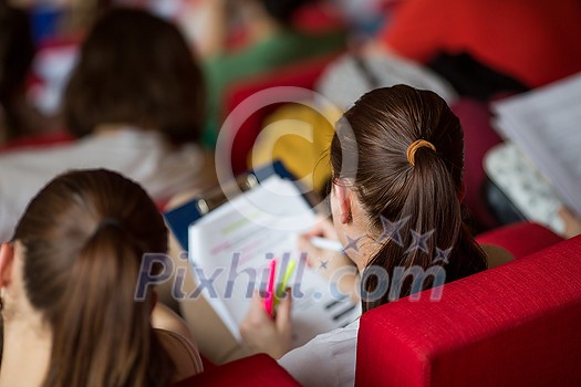 University students sitting in class, taking notes