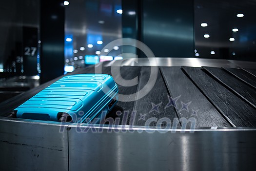 Young woman with her luggage at an international airport, before going through the check-in and the security check before her flight