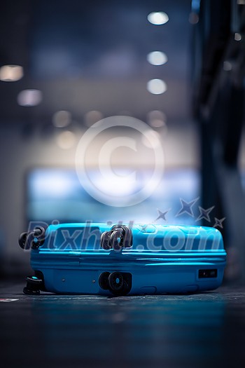 People at an international airport, at the baggage claim zone - motion blurred image