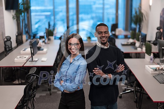 Two happy diverse professional executive business team people woman and African American man looking at camera standing in office lobby hall. Multicultural company managers team portrait. High-quality photo