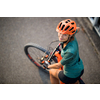 Pretty, young woman with her mountain bike going for a ride past the city limits, getting the daily cardio dose