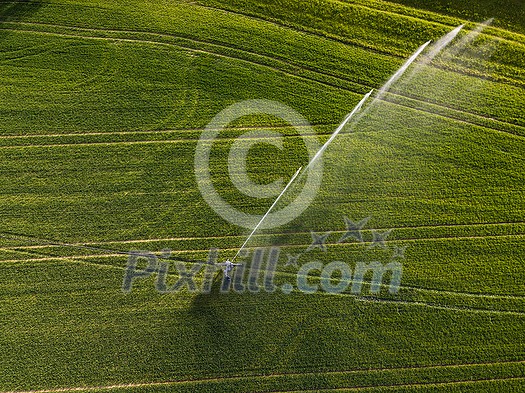 Farmland from above - aerial image of a lush green field being irrigated Farmland from above - aerial image of a lush green field being irrigated