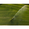 Farmland from above - aerial image of a lush green field being irrigated